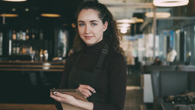 Waitress taking orders in a busy restaurant